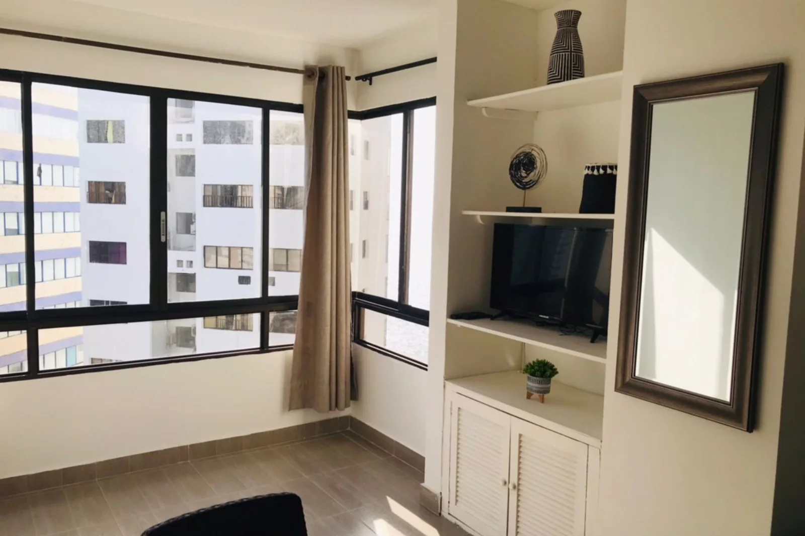 Televisor en la alcoba principal del apartamento vacacional 801AM con vista a la avenida San Martin